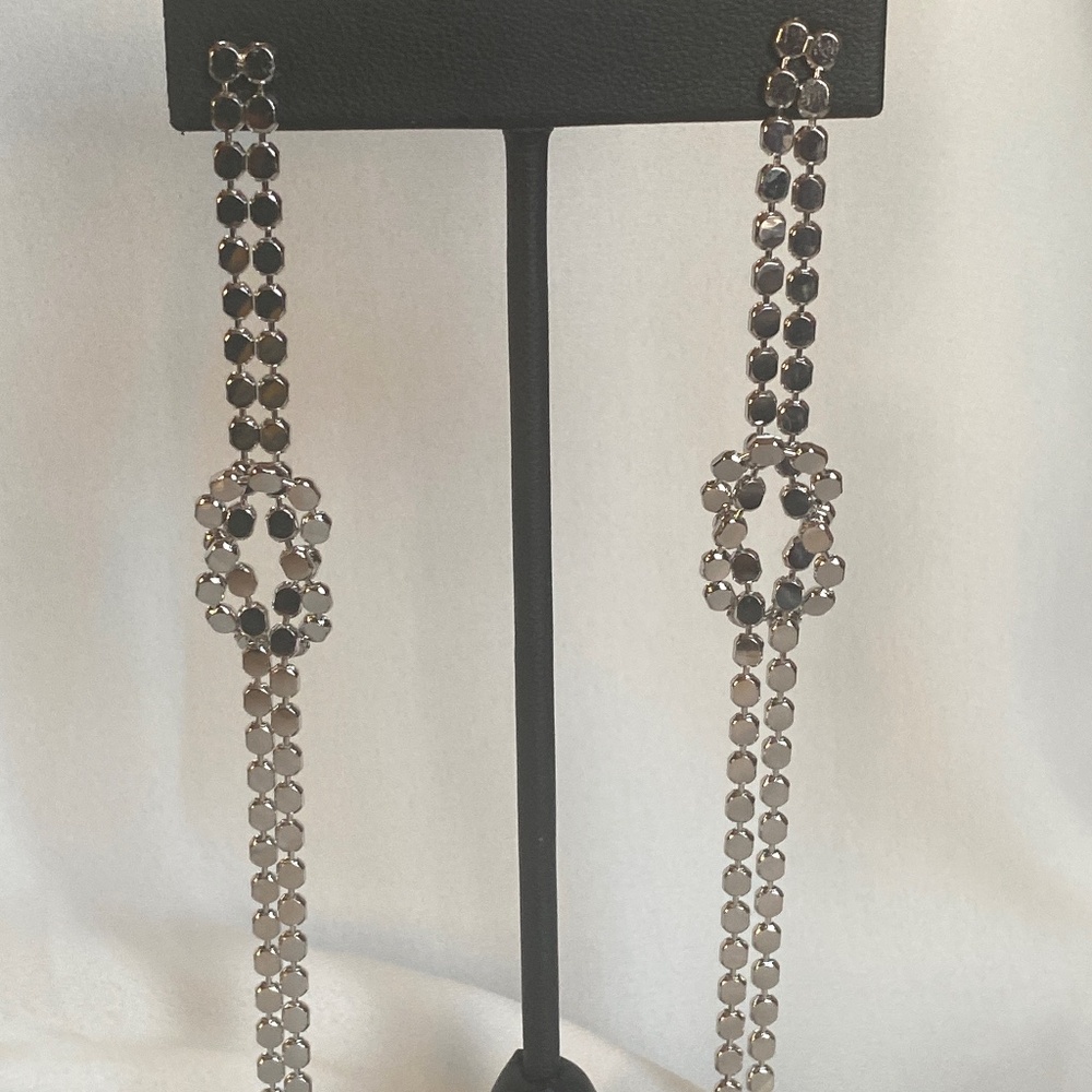 Long sirver tone knot earrings